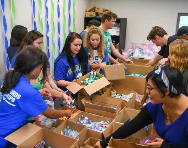 Photo os students assembling care kits after Hurricane Irma for community members.
