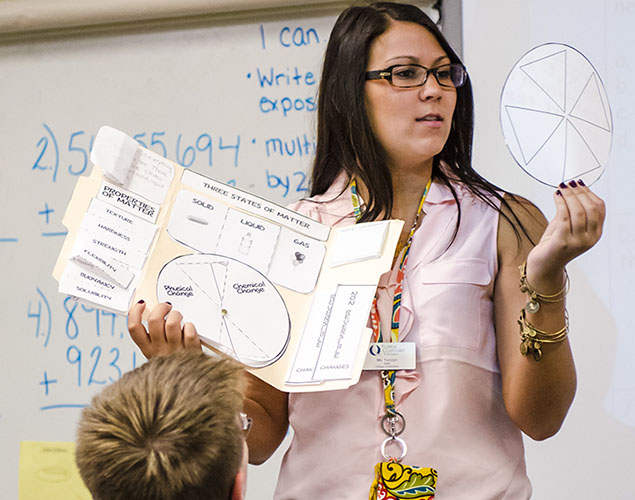 woman instructing group of young children