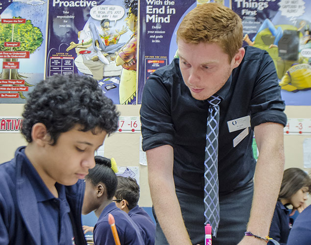 FGCU student instructing a young boy
