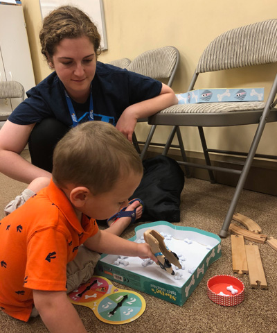 Student playing games with child