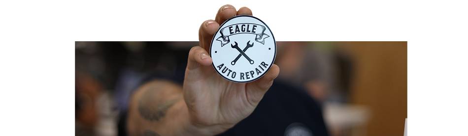 Correy Upstott showing his sticker for Eagle Auto Repair