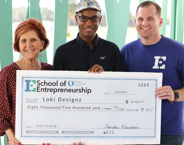 Veteran Entrepreneur Loki Anthony Owner of Loki Designz receiving check to start his busines Veteran Entrepreneur Loki Anthony Owner of Loki Designz receiving check to start his busines after participating in the Veterans Florida Entrepreneurship Program at FGCU